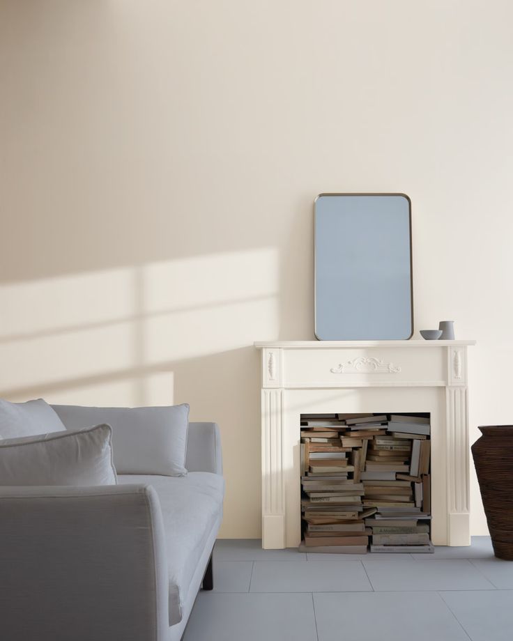 a white couch sitting next to a fireplace in a living room