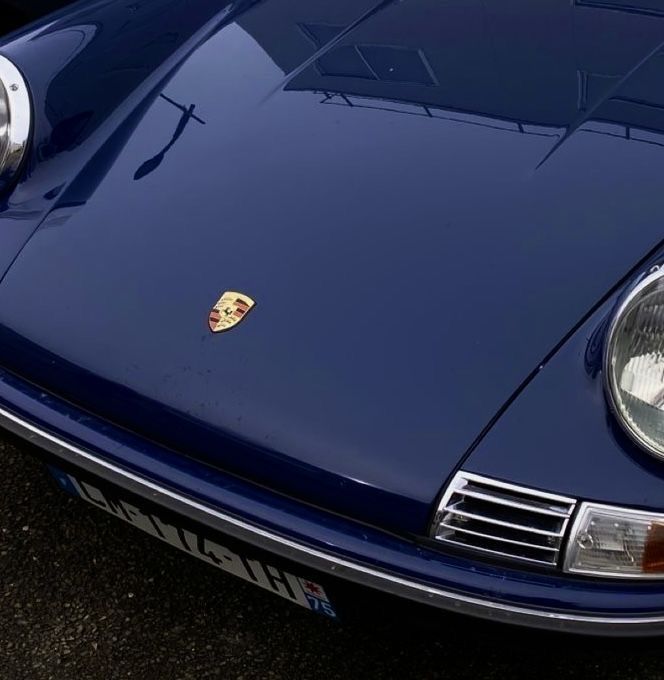 the front end of a blue sports car