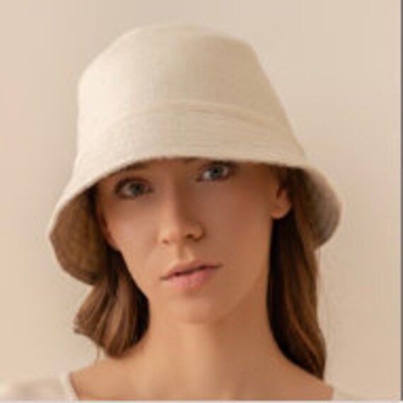 New! A versatile accessory, a Reversible Baby Alpaca Bucket Hat, that delivers two stylish looks in one. Meticulously crafted from a luxurious blend of 65% baby alpaca, 20% merino wool, and 15% nylon, this hat offers unparalleled comfort and sophistication. Choose between different patterns: a timeless plaid pattern or a sleek, unicolor design to match any occasion. Some styles feature a unique textured side or an elegant Pied de Poule pattern paired with a solid side. Great for the city or embr Casual Cream Felt Hat For Winter, Everyday Solid Color One-size Hats, Adjustable Winter Bucket Hat For Everyday Use, Cream Soft Hat, One Size Fits Most, Soft Knit Spring Hats, Winter Bucket Hat For Everyday Use, Adjustable Cream Soft Hat, Adjustable Soft Cream Hat, Reversible Adjustable Hat For Everyday Use