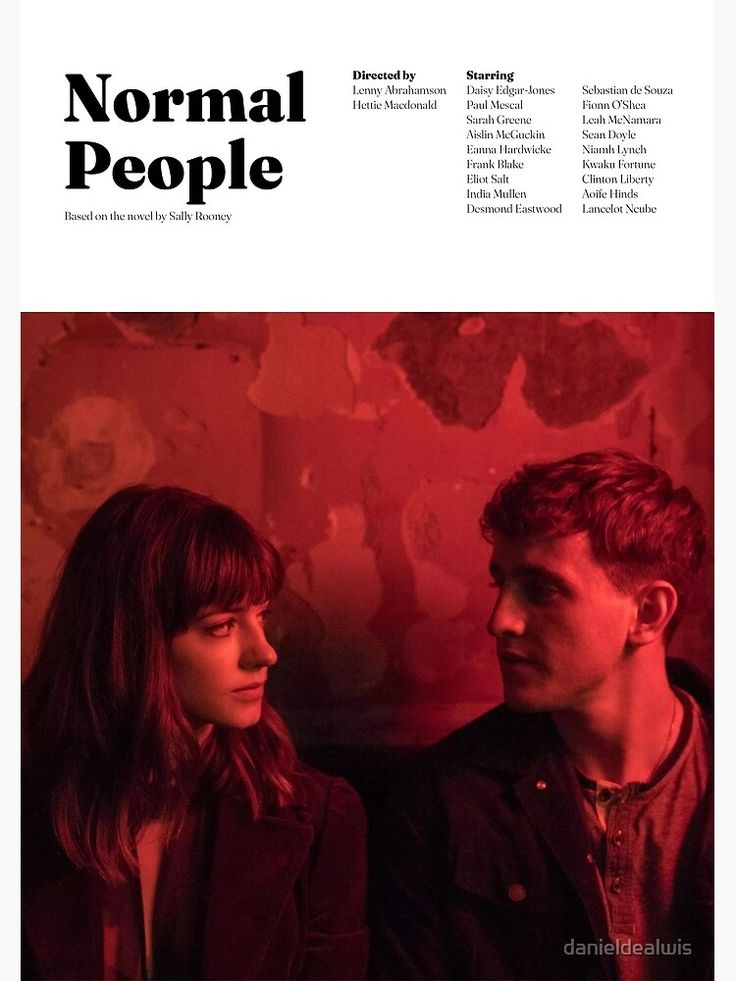 a man and woman sitting next to each other in front of a red wall with the words normal people on it