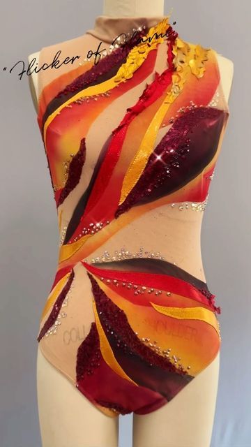 a woman's bodysuit with red, yellow and orange designs on the back