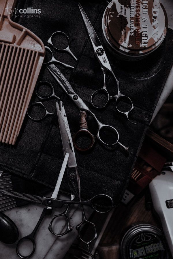 scissors, combs, and other items are laid out on top of a table