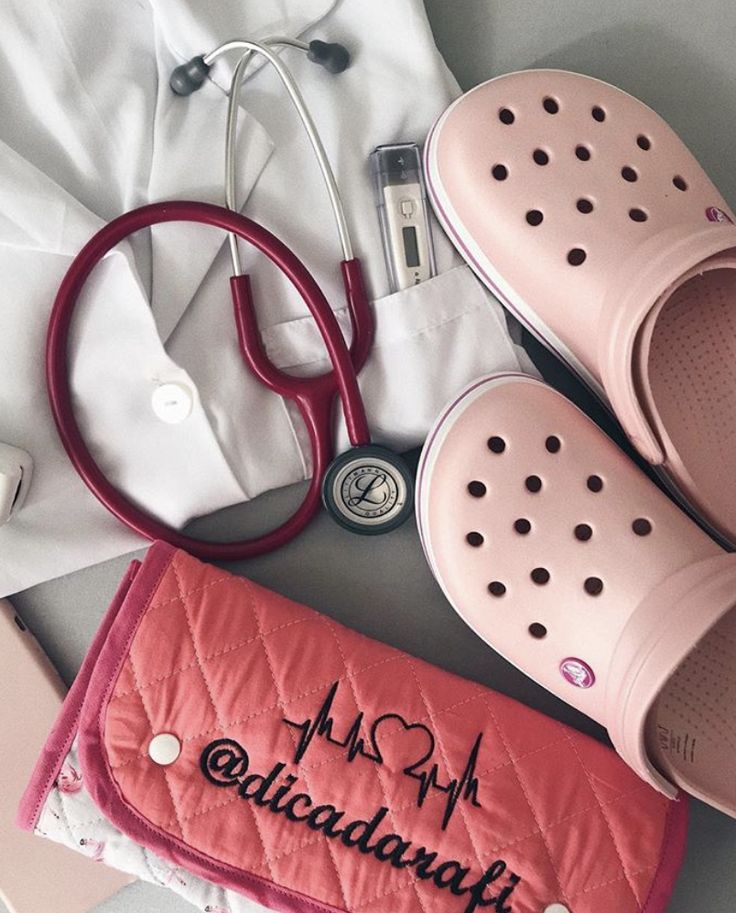 a pair of pink crocs with a stethoscope and medical supplies