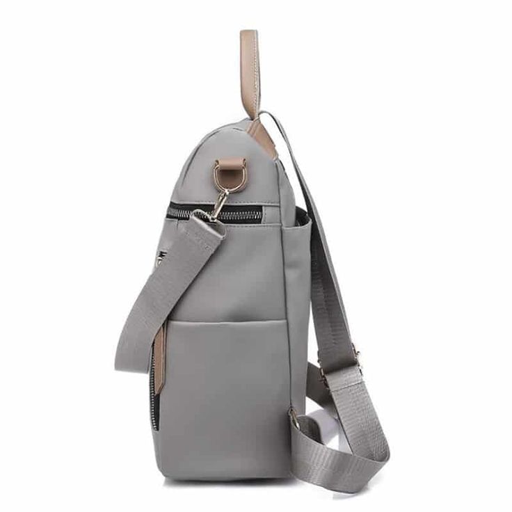 a gray backpack with straps on the front and shoulder strap hanging from it's side