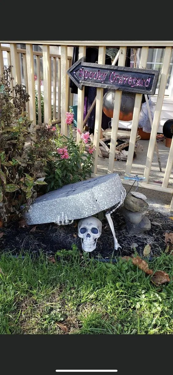 a skateboard that is laying on the ground in front of a fence and flowers