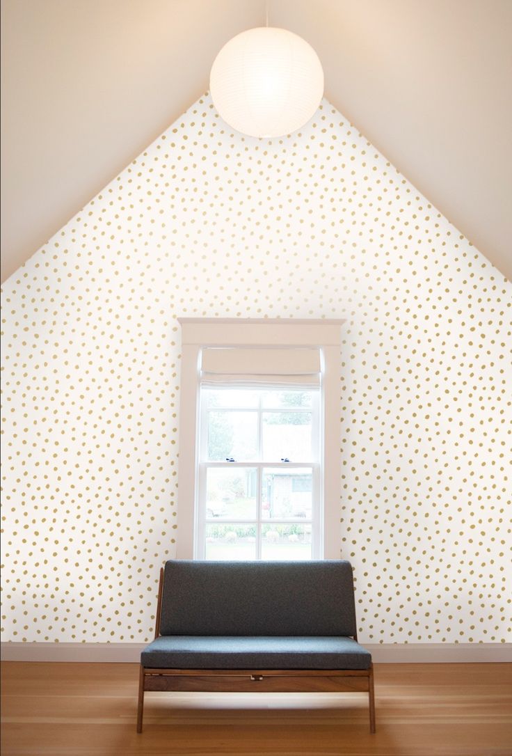 an empty room with a couch in front of a window