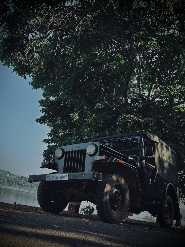 The Nanicheri River can be seen in the background, and the village is located in Kannur, a district in the Indian state of Kerala. And the picture's features a classic Mahindra Jeep. Mahindra Major Jeep, Mahindra Jeep, Kerala, Jeep, Bike, Quick Saves