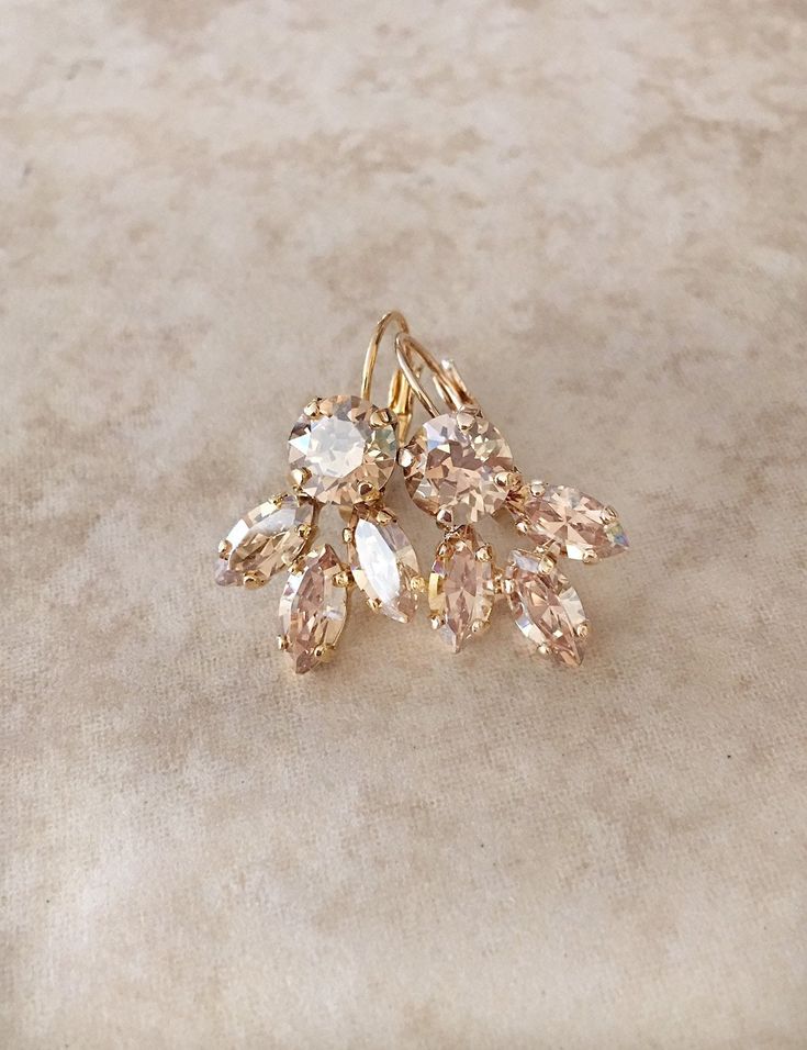 "Gorgeous pair of leaf earrings featuring sparkling champagne crystals. Available in Rose gold, silver or gold plated settings. Please select desired metal finish from the drop down menu at check out. From ear piercing, the earrings are 1 1/4 \" long and 5/8\" wide. The rhinestone cluster portion of the earring is 3/4\" long by 5/8\" wide. Thanks for stopping by." Earring Bridal, Champagne Earrings, Leaf Earring, Crystal Teardrop Earrings, Jewelry Bridesmaid, Earrings Crystal, Swarovski Crystal Earrings, Name Jewelry, Wedding Jewelry Earrings