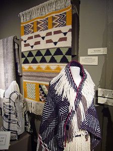 an assortment of blankets and shawls on display