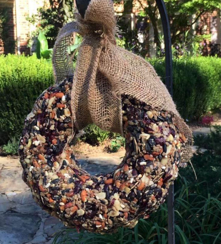 a bird feeder with a burluck hanging from it's side