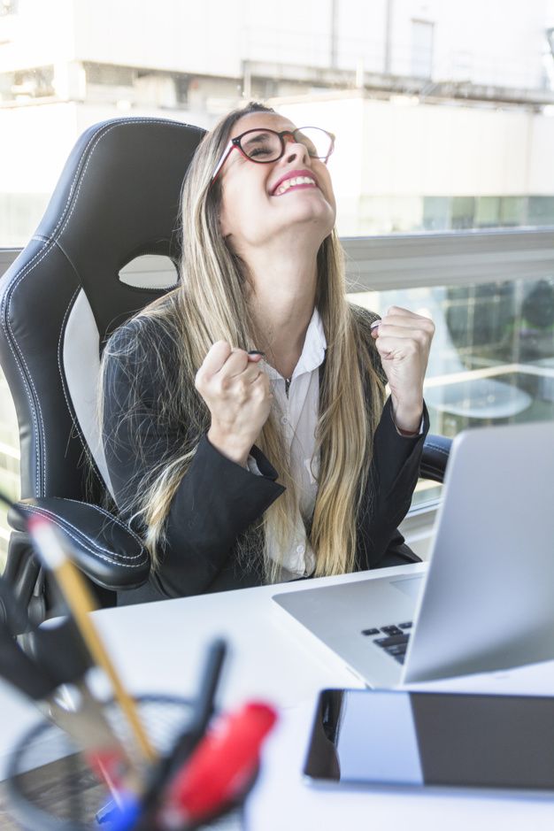 a woman sitting in an office chair with her eyes closed and looking up to the sky