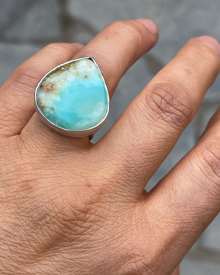 Stunning genuine and exquisite Peruvian Opal stones are up for grabs in the MRJ House for the very first time! Available as a custom ring. Main picture is a mock up of what your rings stones 1-4 will look like. Stone 5 will have a much smaller band like the aquamarine shown in this listing. These stones are all unique in color and variation. This is your opportunity to have a very unique 925 sterling silver custom made gemstone ring. STONES 1-4 **The ring band will be around 9/10mm approx wide f Unique Teardrop Ring With Natural Stones, Unique Opal Ring With Natural Stones For Anniversary, Sterling Silver Freeform Rings As Gifts, Pear-shaped Cabochon Ring As Gift, Anniversary Teardrop Natural Stone Ring, Unique Untreated Sterling Silver Gemstones, Unique Freeform Jewelry With Large Stone, Natural Stone Pear-shaped Jewelry Gift, Artisan Untreated Open Ring Jewelry