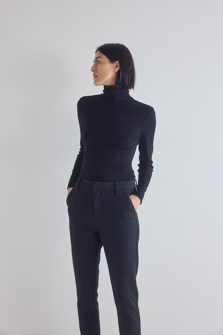 Made from premium ribbed fabric, this turtleneck sweater offers a luxurious feel against the skin. The ribbed texture adds depth to its design while providing a flattering and form-fitting silhouette that accentuates your curves in all the right places Black High Neck Turtleneck For Work, Stretch Ribbed Turtleneck For Layering, Black Ribbed Turtleneck For Workwear, Fitted Mock Neck Top For Workwear In Fall, Fitted Mock Neck Top For Fall Workwear, Winter Fitted Mock Neck Top With Ribbed Neckline, Fitted Ribbed Mock Neck Top For Winter, Chic Fitted Mock Neck Top For Winter, Winter Stretch Mock Neck Top For Work