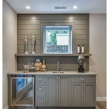 an empty kitchen with stainless steel appliances and wood flooring