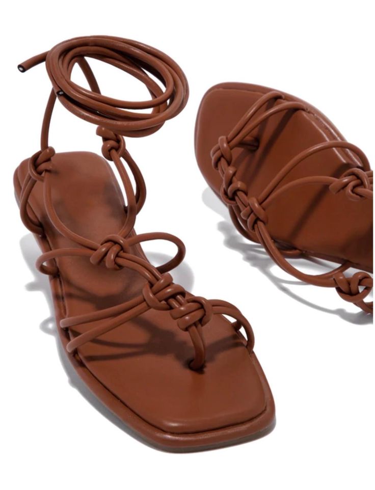 SIZE & FIT HEEL HEIGHT APPROX: 0.5" SHOE MODEL SUGGESTION: TRUE TO SIZE ALL MEASUREMENTS ARE MADE ON A SIZE 6.5 THERE MAY BE SLIGHT MEASUREMENT VARIATIONS BASED ON SIZE. PRODUCT DETAILS ADJUSTABLE AROUND-THE-ANKLE LACE-UP CLOSURE STRAPPY ASYMMETRIC DETAILING LIGHTLY PADDED INSOLE BROWN LACE-UP SANDALS Roman Sandals Outfit, Brown Strap Sandals, Senior Brunch, Lace Up Sandal Heels, Tan Strappy Sandals, Shoes Fashion Photography, Shoe Model, Roman Sandals, Sandals Outfit