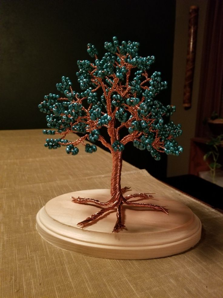 a small beaded tree sitting on top of a table