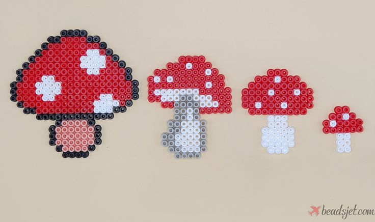 the pixel art is made out of different types of beads and plastic material, including mushrooms