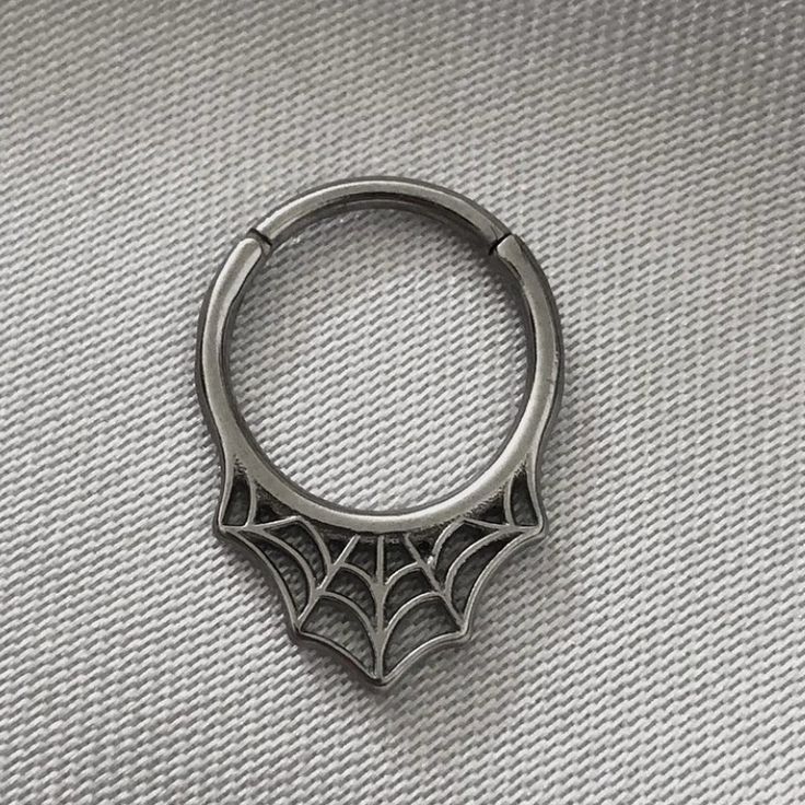 a metal ring with spider web on it