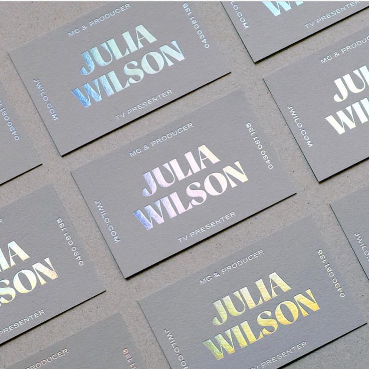 business cards with metallic foil on them are arranged in rows and placed next to each other