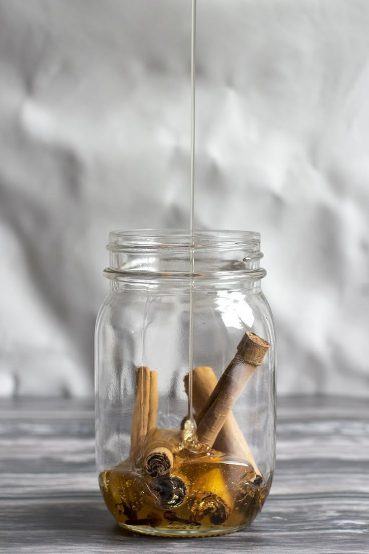 a glass jar filled with cinnamons and spices