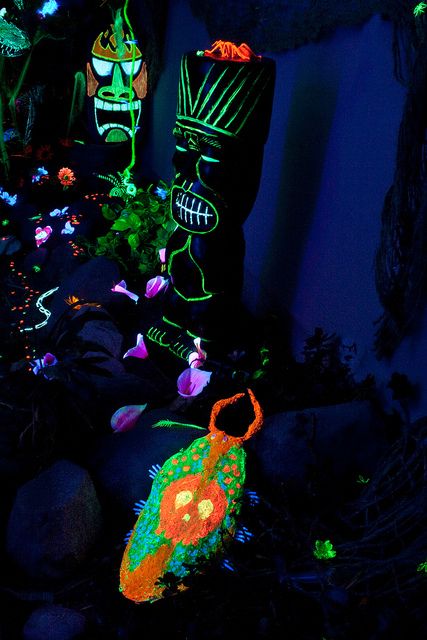 halloween decorations are lit up in the dark, with green and orange lights on them