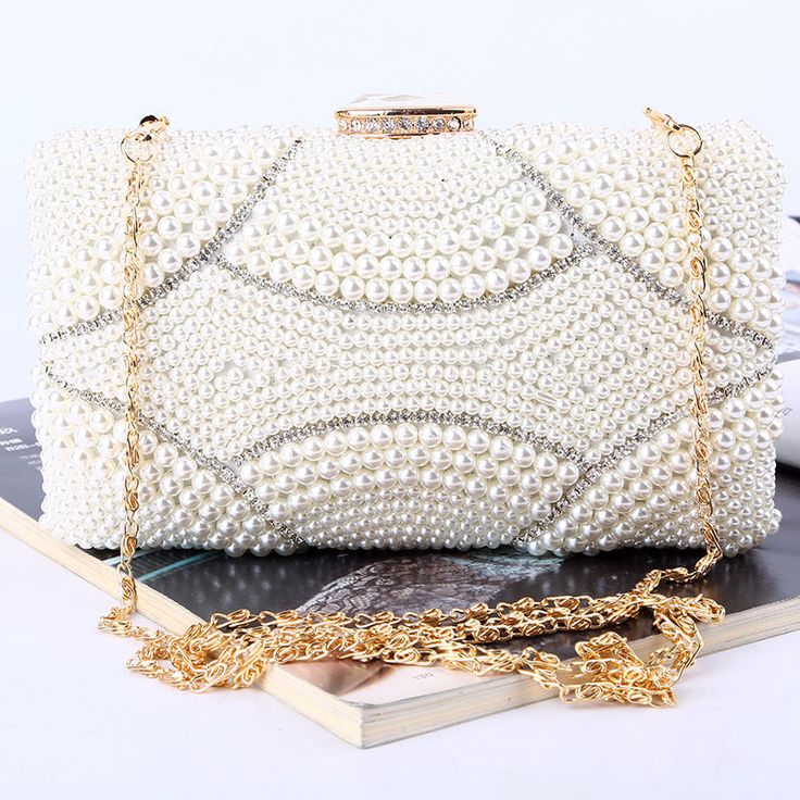 The Violeta Luxury Pearl Clutch Bag has a stunning and luxurious look. This bag is made of high-quality materials and has enough space for your essentials while still looking elegant at the same time. Its embroidered exterior bespeaks its beauty, while its exquisite frame demonstrates luxury. Exclusively available in c Luxury Pouch Bag With Pearl Handle, White Rectangular Case Clutch, Elegant White Rectangular Shoulder Bag, Elegant Handheld Pouch For Everyday, Luxury Pearl-embellished Clutch For Formal Occasions, Luxury Pearl Embellished Clutch For Formal Occasions, Luxury Pearl Embellished Clutch For Formal Events, Luxury Formal Clutch With Pearl Handle, Luxury White Rectangular Clutch