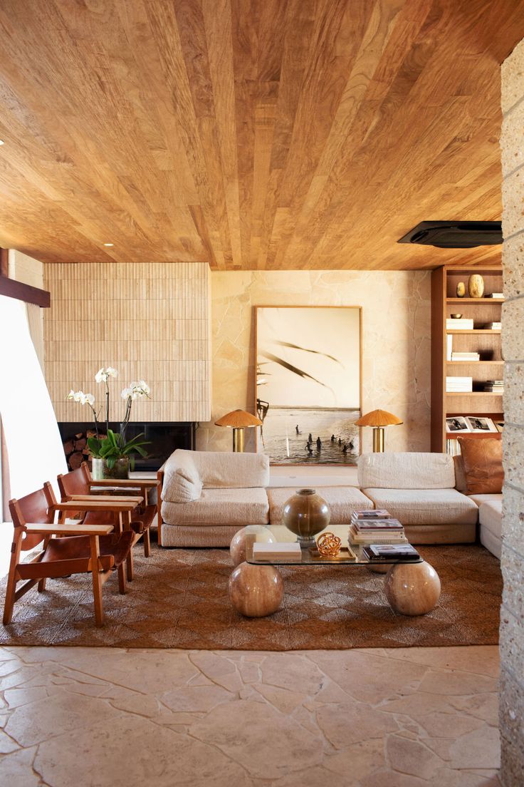 the living room is clean and ready for guests to use it's natural wood ceiling