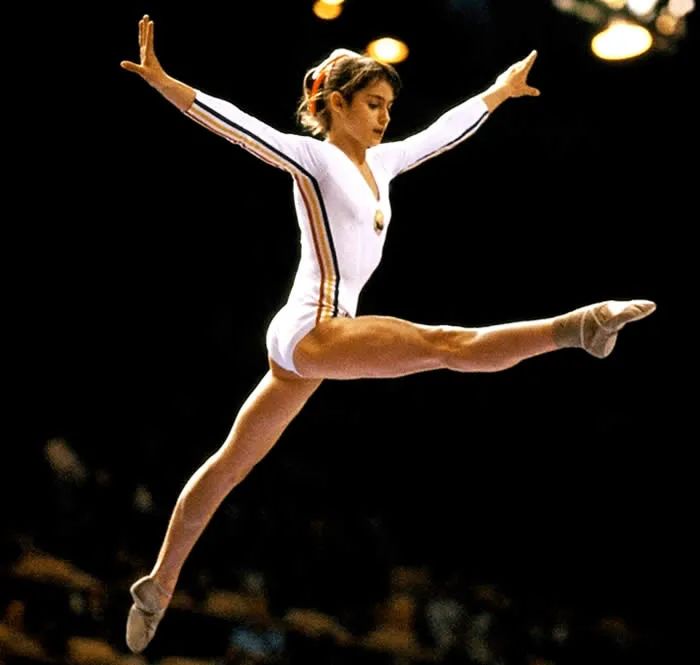 a woman is performing on the balance beam