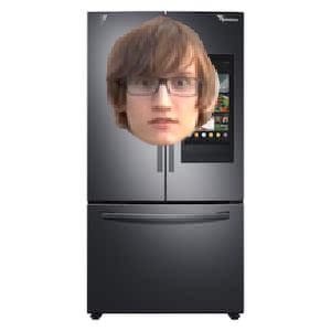 a woman's face is shown on the side of a black refrigerator freezer