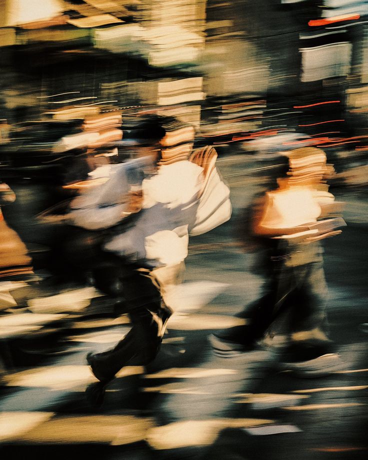 blurry photograph of people riding bikes in the street