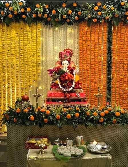 a decorated stage with an idol in the middle