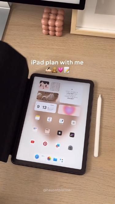 an ipad sitting on top of a wooden desk