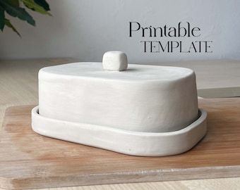 there is a white cake on a wooden tray with the words printable template above it