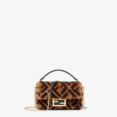 Iconic small Baguette bag made from soft sheepskin with a brown and black FF motif print. Decorated with an FF clasp. Featuring a front flap, magnetic clasp, unlined internal compartment with pocket and gold-finish metalware. The bag can be carried by hand or worn either on the shoulder or cross-body thanks to the handle and chain shoulder strap, both detachable. Holds a 6.7-inch smartphone, Mini Trifold card holder or wallet, keys and lipstick. Made in Italy. One Size Fendi Baguette Mini, Fendi Mini Baguette, Fendi Logo Design, Mini Baguette, Fendi Store, Baguette Bag, Black Leather Bags, Mini Shoulder Bag, Fendi Baguette