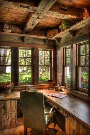 an old log cabin home office with desk and chairs