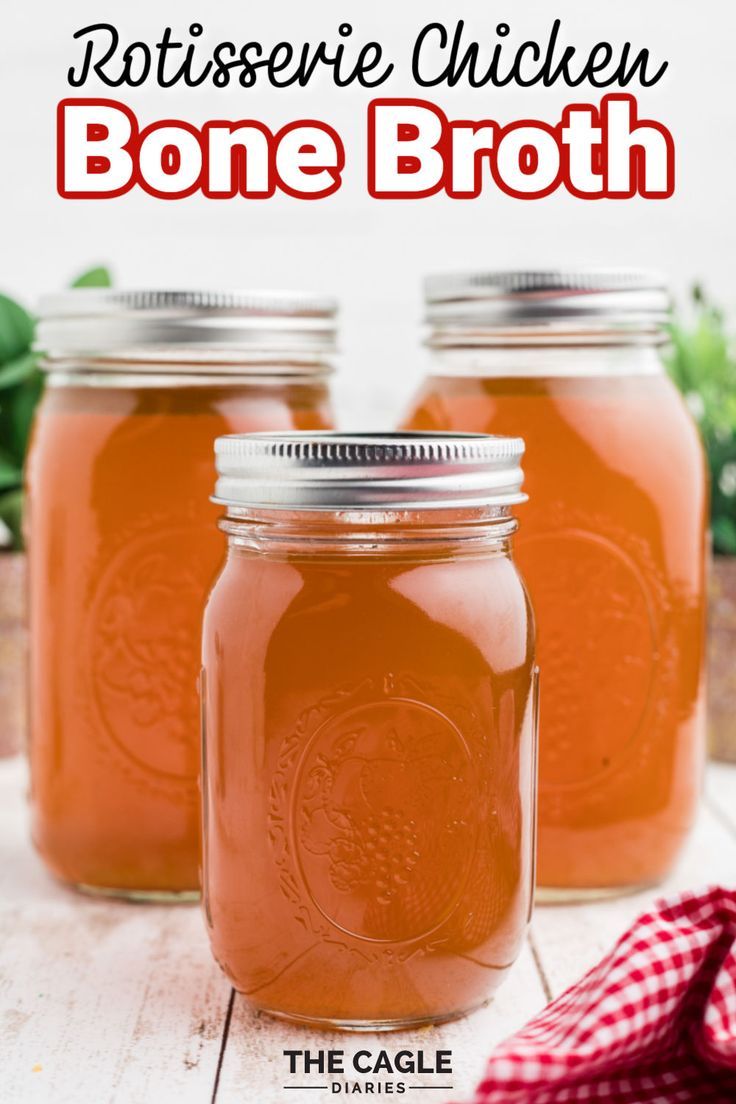 three jars filled with bone broth sitting on top of a wooden table next to a red and white checkered napkin