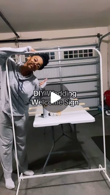 a man standing in front of a white table with an ironing board on it