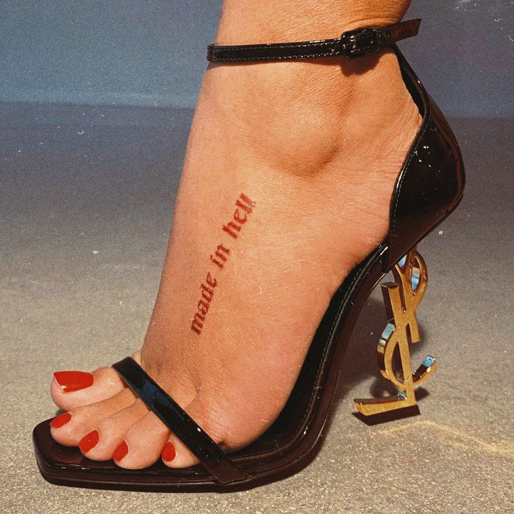 a woman's foot with a tattoo on it