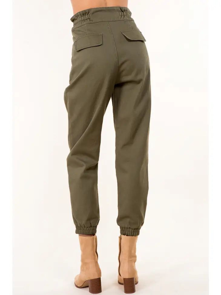 Tie Waist Paperbag Cotton Pants - Take your wardrobe up a notch with these Tie Waist Paperbag Cotton Pants in a trendy olive hue! Designed in LA, they're perfect for pairing with something unique from FABA's Wearable Art collection. Get your outfit ready and set to WoW! Ships from Los Angeles. Color: Olive Color: Olive Fabric: Details: Woven Cotton Pants Inseam: 26" Designed in and shipped from Los Angeles. Imported: Asia Fabric: 100% Cotton Care: Wash cold The lovely Model is wearing a size S. Olive High-waisted Bottoms With Pockets, Olive Straight Pants With Belt Loops, High-waisted Olive Pants For Work, High Waist Olive Pants For Work, Olive Cargo Pants For Spring Workwear, Olive High Waist Utility Bottoms, Olive Cargo Style Bottoms For Work, Chic Olive High-waisted Pants, Olive Cargo Style Workwear Bottoms