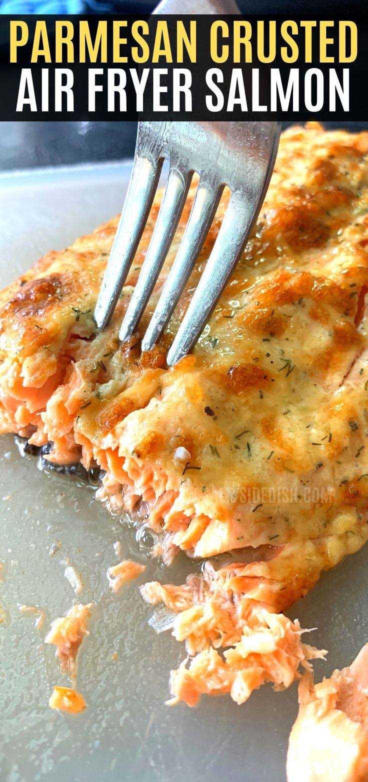 a close up of food on a plate with a fork and text overlay that reads ninja food air fryer salmon