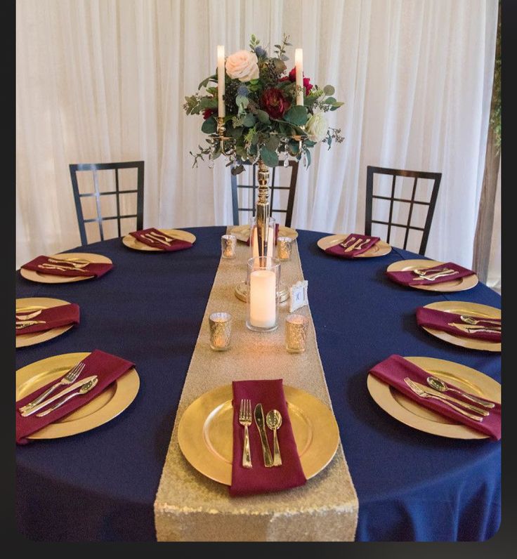 the table is set with gold and red place settings