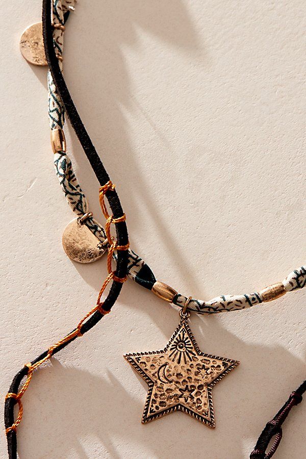 Get that effortlessly layered look with this multi-strand necklace, featured in a mixed-material design with a cascading lariat, beaded accents, and star pendants. **Features:** Layered style, lariat design, suede and textile chains, knotted details, mixed beads, star pendants, adjustable clasp closure | Dandelion Lariat Necklace by Free People in Black Bohemian Necklace With Star Charm For Festivals, Bohemian Star Charm Necklace For Festivals, Bohemian Festival Necklaces With Star Charm, Bohemian Star Jewelry For Festivals, Bohemian Star-shaped Jewelry For Festivals, Bohemian Star-shaped Festival Jewelry, Festival Multi-strand Layered Necklace, Adjustable Multi-strand Bohemian Layered Necklace, Bohemian Jewelry With Star Charm