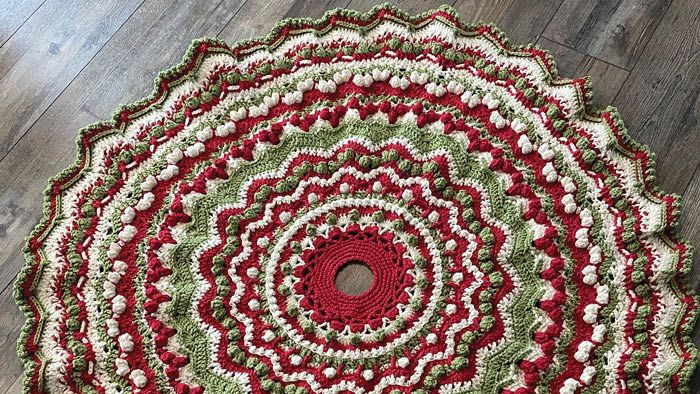 a red and green crocheted rug on the floor