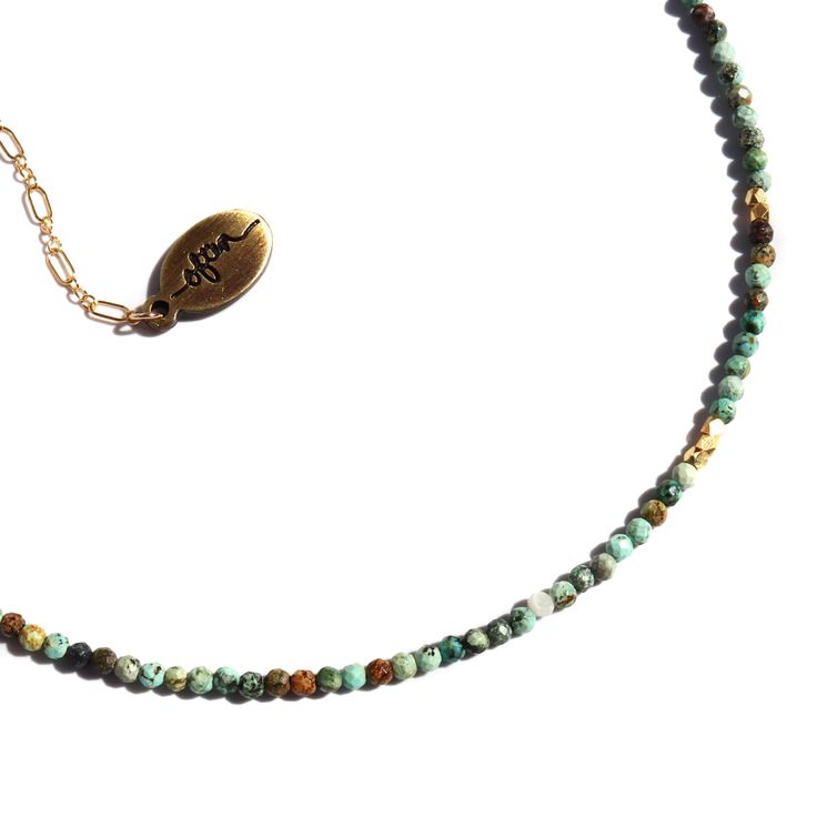 The Gemstone Choker Necklaces are perfect for adding some subtle sparkle, and are made with real, ethically sourced gemstone beads. African Turquoise is believed to promote growth and personal development, as well as enhancing positivity. This stone is useful for working with the throat chakra, helping to awaken one to their true calling. It is also believed to enhance optimism and smooth out fickle emotions, bringing in more balance and stability. Length: 14.5“ The 14k Gold Fill chain is adorned with a draping “Often Wander” charm down the back. Handmade in San Francisco and San Diego, Ca Gemstone Choker Necklace, Gemstone Choker, African Turquoise, Throat Chakra, Gold Filled Chain, Personal Development, Gemstone Beads, Chakra, Gold Filled