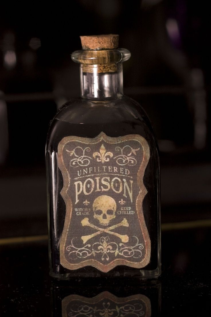 an empty bottle with a skull and crossbones on the label sitting on a table