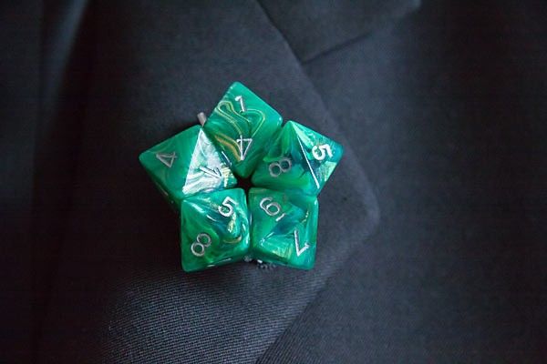 a green dice sitting on top of a black suit