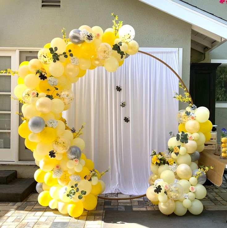 a bunch of balloons that are in the shape of a circle on a table outside