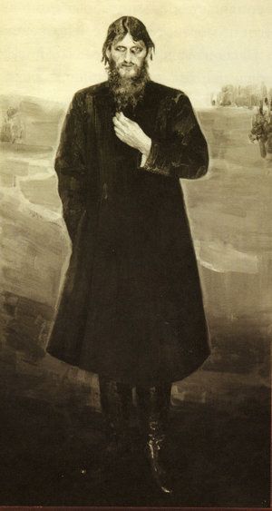 an old photo of a man with a beard and long coat standing in front of a painting