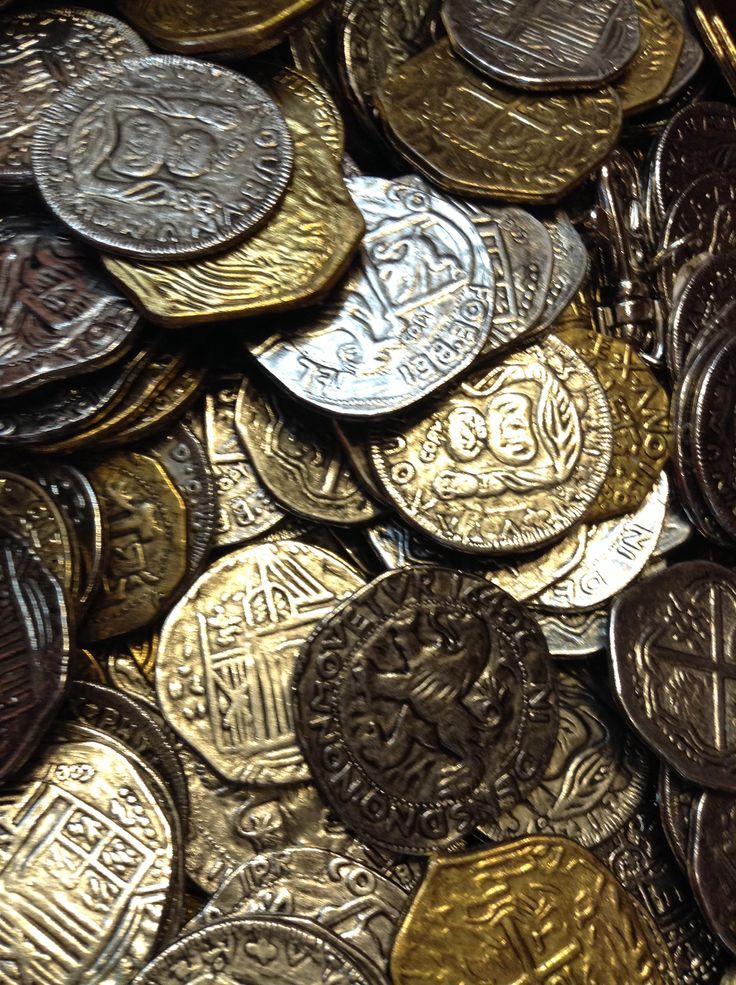 many different types of coins are stacked on top of each other in this pile,