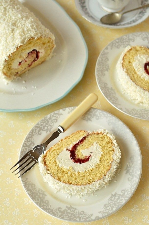 there is a piece of cake on the plate and another slice has been cut in half